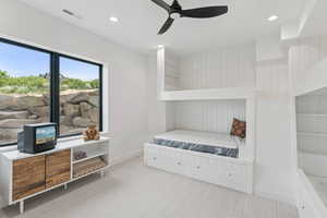 Carpeted bedroom featuring recessed lighting and ceiling fan