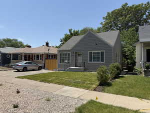 Bungalow-style house with a front lawn and a shingled roof