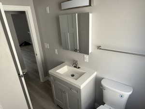 Bathroom featuring vanity and wood finished floors