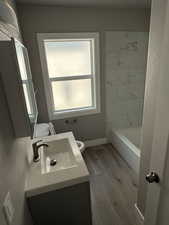 Full bath featuring vanity and wood finished floors