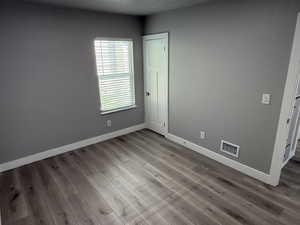 Empty room with baseboards and wood finished floors