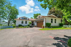 View of front of house with a garage and driveway