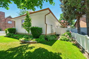 View of side of home featuring brick siding and a fenced backyard