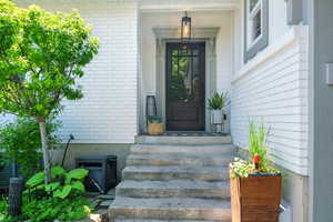 Entrance to property featuring brick siding