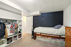 Carpeted bedroom with a textured ceiling