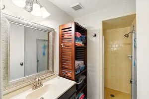Bathroom with a stall shower and vanity