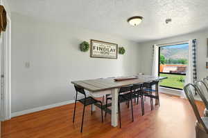 Dining room featuring a textured ceiling and wood finished floors