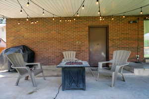 View of patio / terrace featuring an outdoor fire pit and a grill