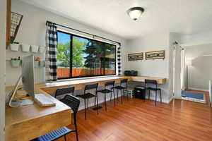 Office area featuring a textured ceiling and wood finished floors
