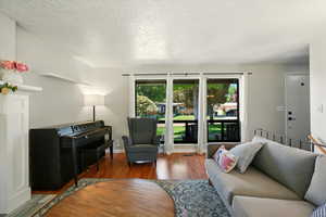 Living room with wood finished floors and a textured ceiling