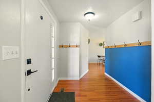 Hall featuring a textured ceiling and wood finished floors