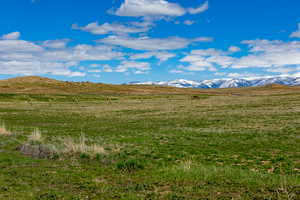 View of mountain backdrop with rural landscape
