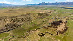 Aerial view of property's location featuring a mountainous background and rural landscape