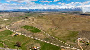 Aerial view of property and surrounding area with mountains, rural landscape, and property parcel outlined