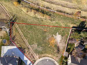 Aerial view of property and surrounding area with property boundaries highlighted