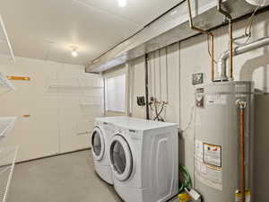 Laundry room with gas water heater and washing machine and dryer