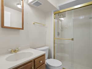 Full bath with a stall shower and vanity