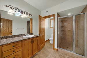 Bathroom with vanity and a shower stall