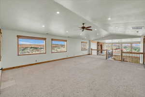 Unfurnished living room featuring ceiling fan, vaulted ceiling, carpet floors, and recessed lighting