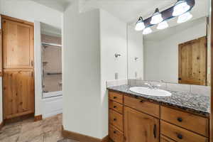 Bathroom with vanity and  shower combination