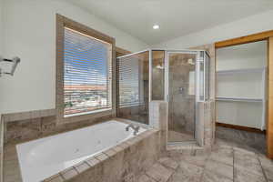 Full bathroom with a tub with jets and a stall shower