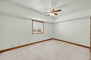 Spare room with a ceiling fan and carpet floors