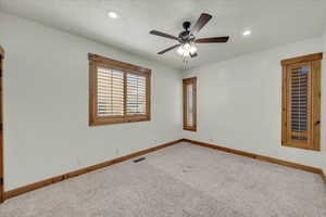 Unfurnished room featuring carpet flooring, ceiling fan, and recessed lighting