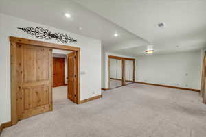 Spare room with light carpet and recessed lighting