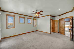 Unfurnished bedroom with carpet, ornamental molding, recessed lighting, and a ceiling fan