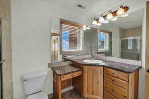 Full bath featuring vanity and a shower stall