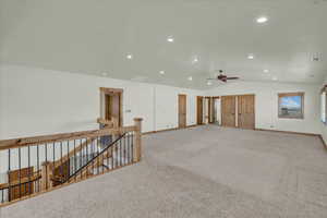 Empty room with vaulted ceiling, recessed lighting, ceiling fan, and light colored carpet