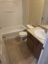 Bathroom featuring vanity, bathtub / shower combination, and tile patterned floors
