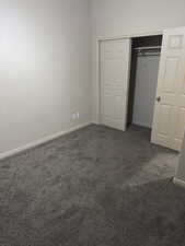 Unfurnished bedroom with carpet and a closet