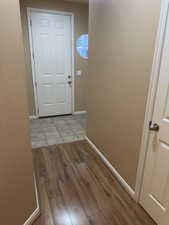 Doorway to outside with baseboards and light wood-style floors