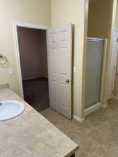 Bathroom featuring a stall shower and vanity