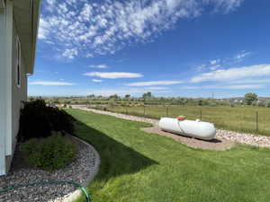 View of yard with a rural view