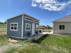 Rear view of property featuring a yard