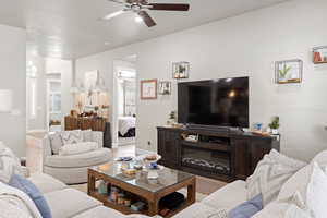 Living area featuring a ceiling fan and wood finished floors