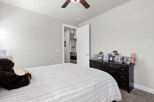 Carpeted bedroom with baseboards and a ceiling fan