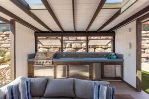 View of patio featuring area for grilling and a sink