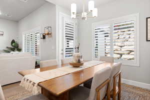 Dining room featuring a chandelier and light wood-type flooring