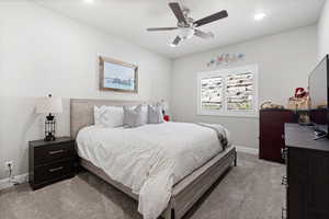 Bedroom featuring light carpet, recessed lighting, and ceiling fan