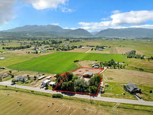 Aerial view of sparsely populated area with a mountain backdrop and property boundaries highlighted