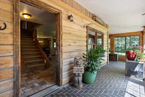 Doorway to property featuring a porch