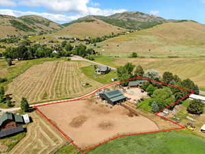 Aerial view of sparsely populated area featuring property boundaries highlighted and a mountain backdrop
