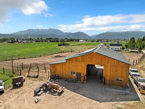 View of outbuilding with a mountain view, a view of countryside, and an exterior structure