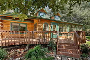 View of front of home featuring a sunroom and a deck