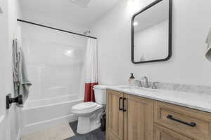 Full bath with vanity, shower / bath combination with curtain, and tile patterned floors