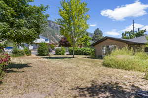 View of yard with a deck with mountain view