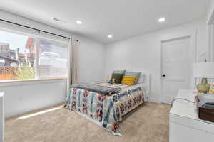 Carpeted bedroom with recessed lighting